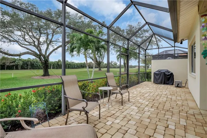 View of patio / terrace featuring glass enclosure and area for grilling