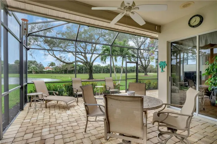 Sunroom with a water view and ceiling fan