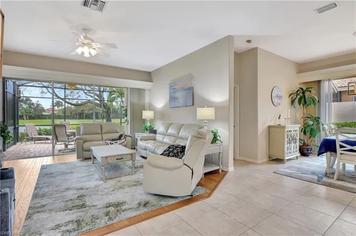 Living room with ceiling fan and light tile patterned floors