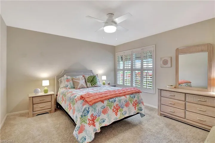 Carpeted bedroom with ceiling fan