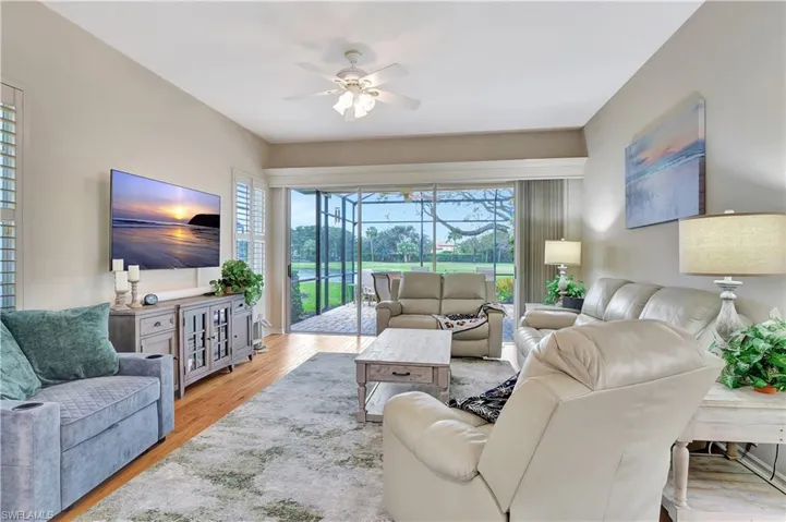 Living room featuring ceiling fan and light hardwood / wood-style floors