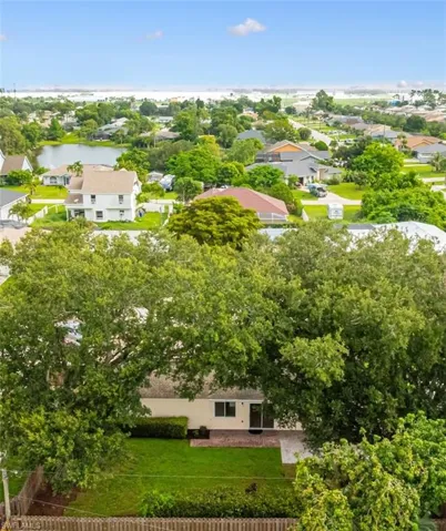 Aerial perspective of suburban area with a nearby body of water