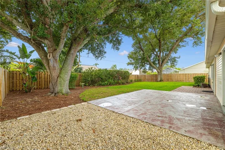 Fenced backyard with a patio area