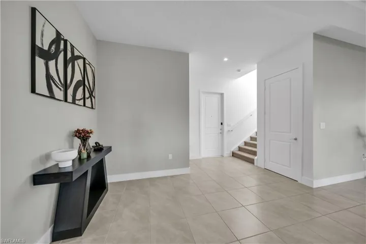 Hall with stairway and light tile patterned flooring