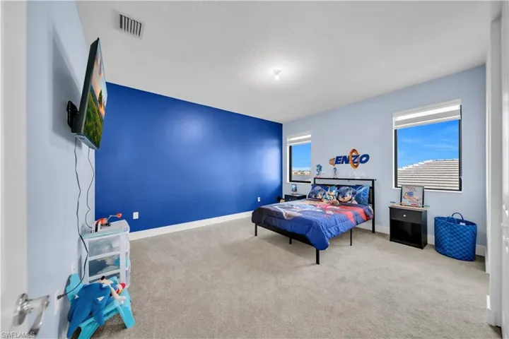 Bedroom featuring carpet floors and baseboards