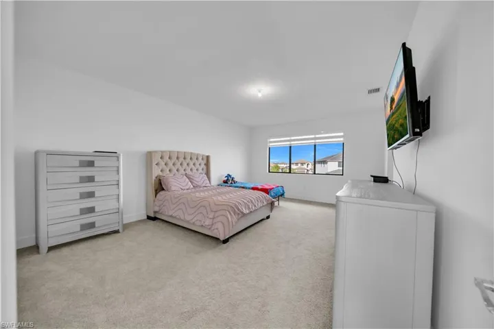 Carpeted bedroom with baseboards
