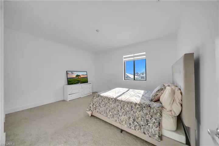 Bedroom with carpet flooring and baseboards