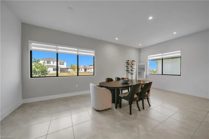 Dining area featuring light tile patterned floors, recessed lighting, and plenty of natural light