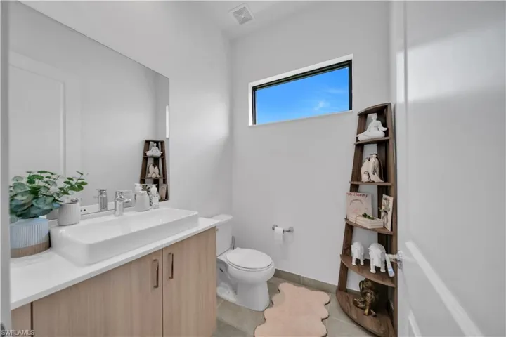 Bathroom with vanity and light tile patterned flooring