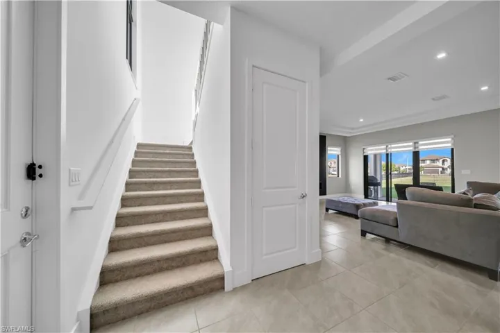 Staircase featuring recessed lighting and tile patterned flooring