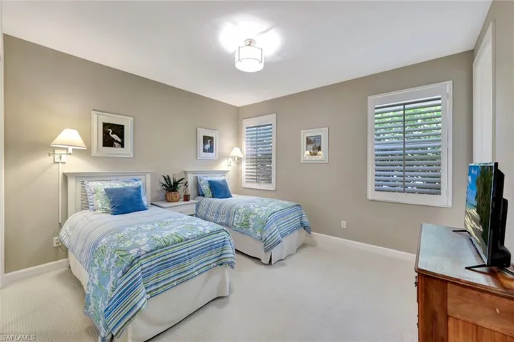 Bedroom with light colored carpet