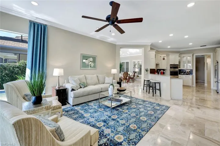 Living room featuring ceiling fan and crown molding