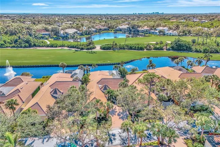Birds eye view of property with a water view