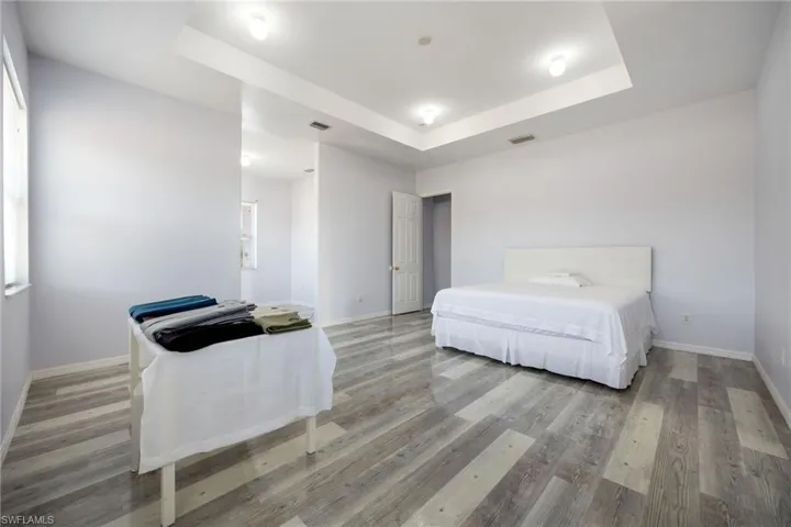 Wonderful tray ceiling adds to the open bright feeling of the master bedroom