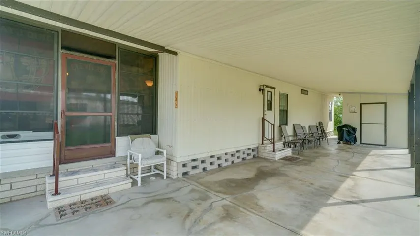 Two entrances to this home. And, the carport easily holds two cars and...a golf cart.
