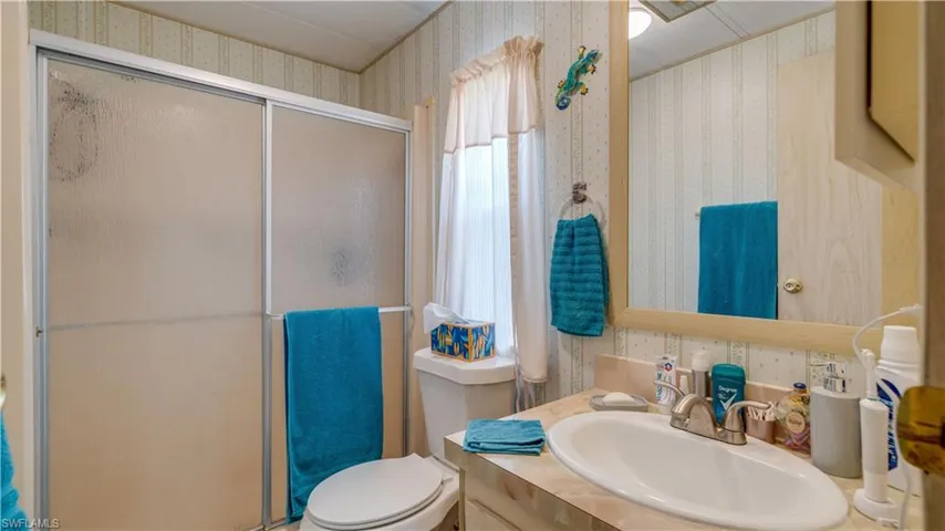 The master bath features new flooring, a new sink bowl and fixture, a new showerhead, a new raised toilet, and a new light fixture. All updates: 2023!