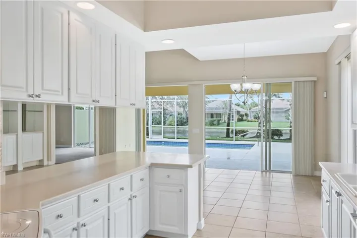 Kitchen with white cabinets, recessed lighting, pendant lighting, light countertops, and light tile patterned floors