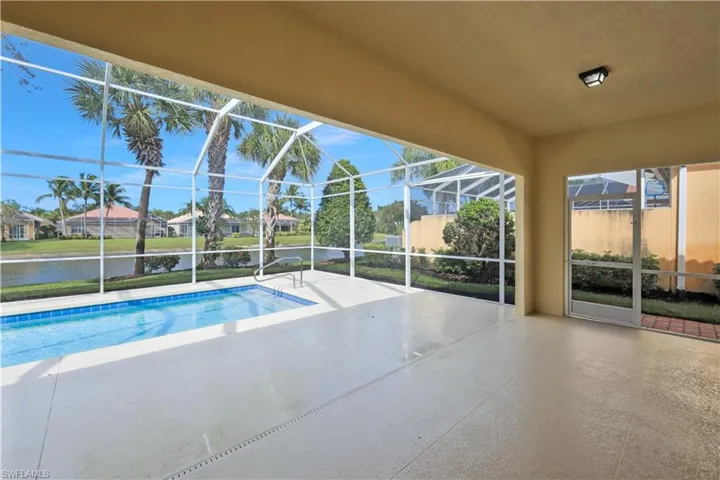 Outdoor pool with a patio, a sunroom, a lanai, a water view, and a residential view