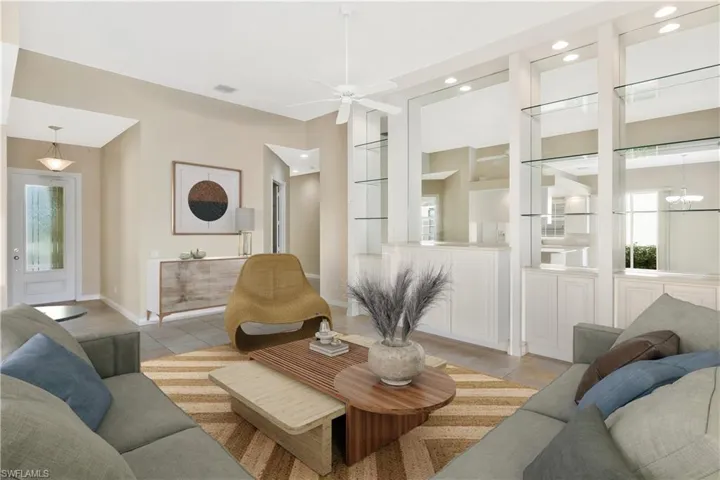 Living area featuring recessed lighting, a ceiling fan, built in shelves, and tile patterned flooring
