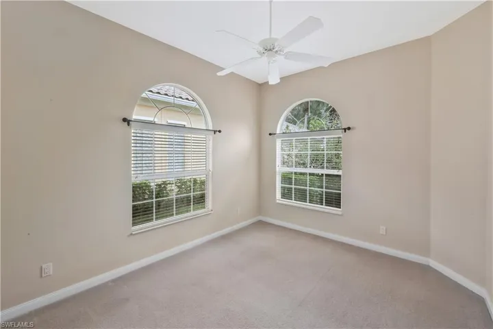 Unfurnished room with light colored carpet and ceiling fan