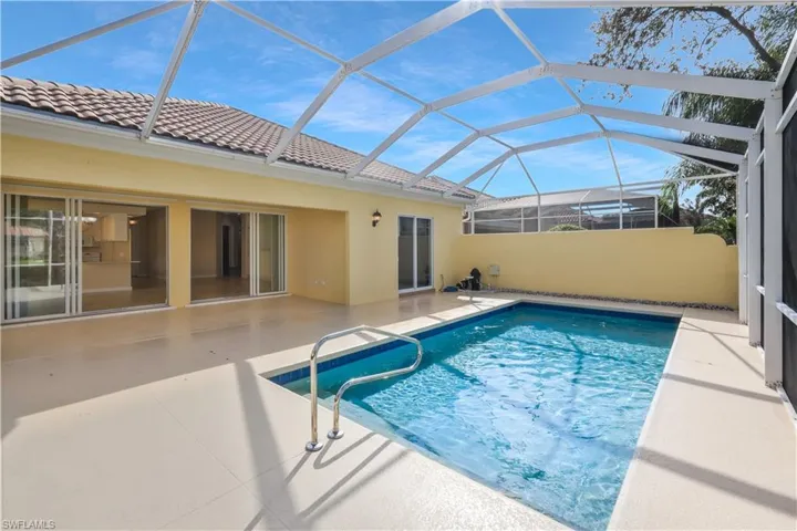 Outdoor pool with a sunroom, a patio, and a lanai