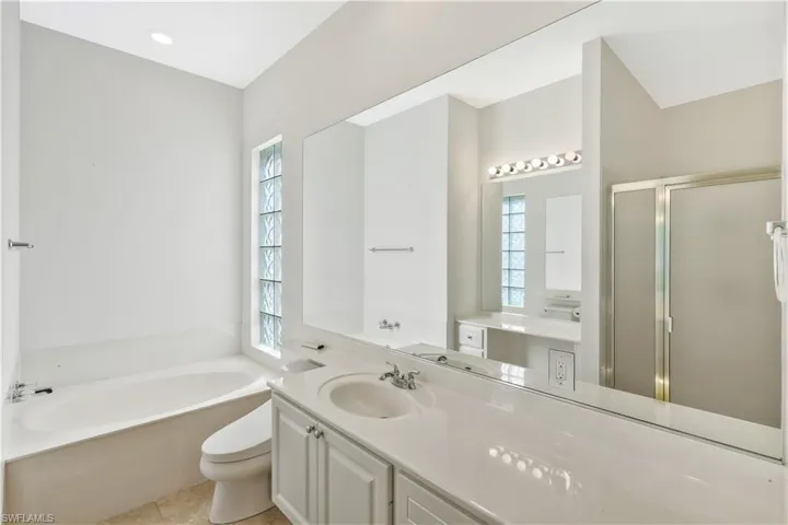 Full bathroom with a garden tub, a stall shower, and vanity
