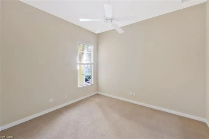 Spare room with light carpet and ceiling fan