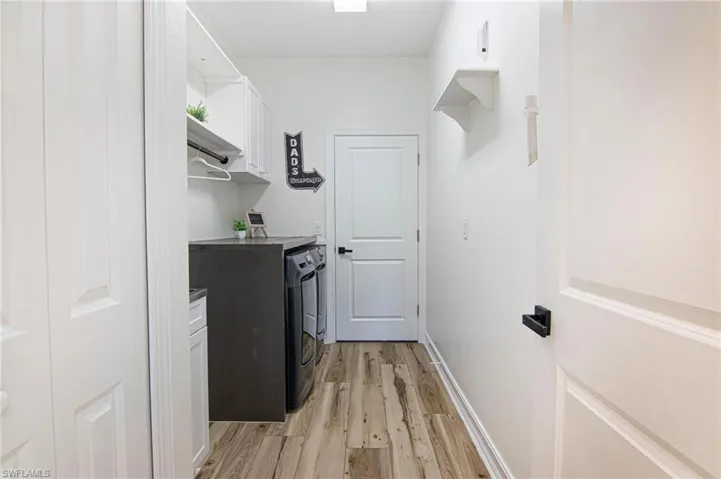 Laundry with built-in cabinets and laundry sink