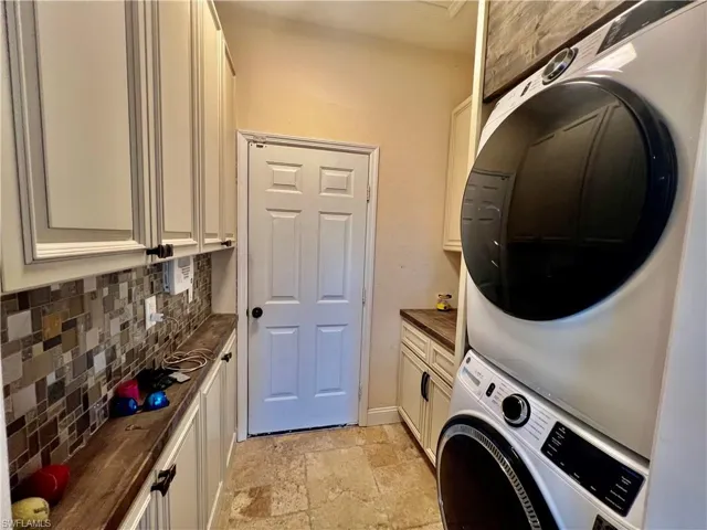 Indoor laundry room with extra cabinets and storage.