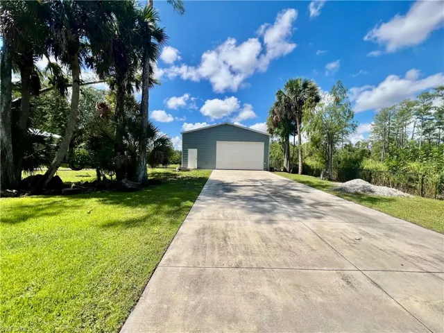 Extra long driveway leading to detached garage with plenty of parking.