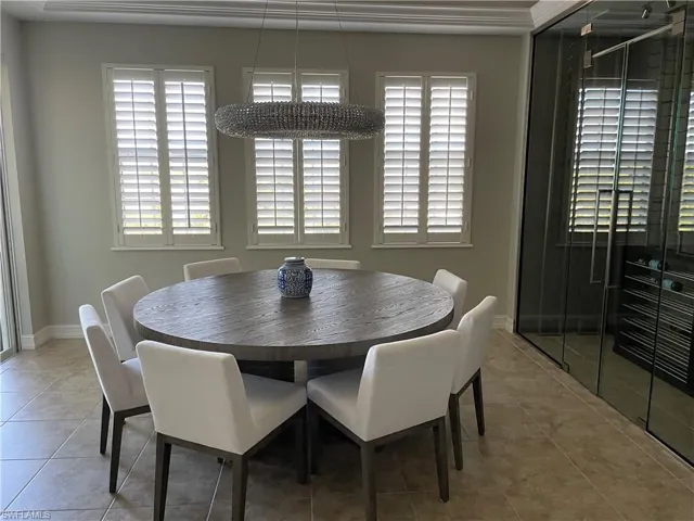 Tiled dining space with crown molding
