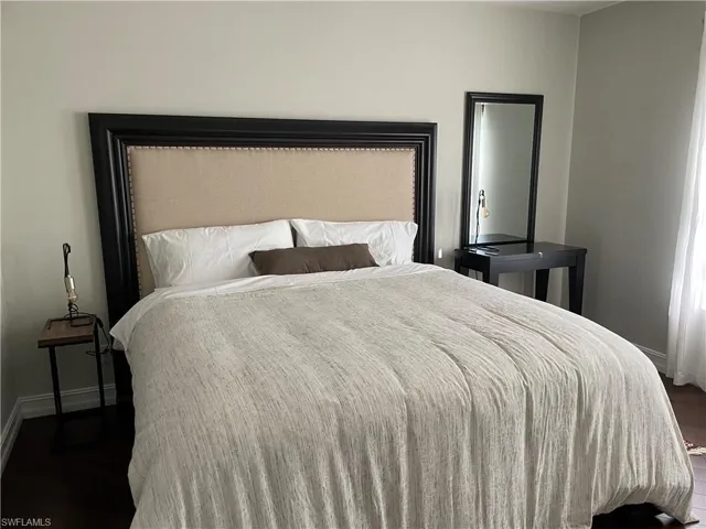 Bedroom with dark wood-type flooring