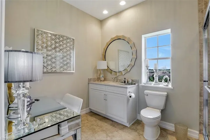 Bathroom featuring tile flooring, a wealth of natural light, and toilet
