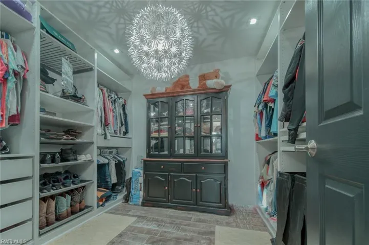 Walk in closet with a chandelier