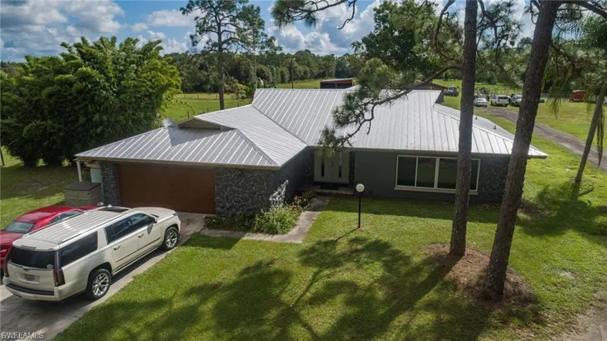 View of front of house with stone siding and a front yard
