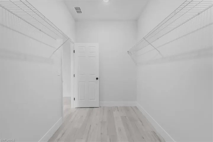 Primary bedroom walk in closet