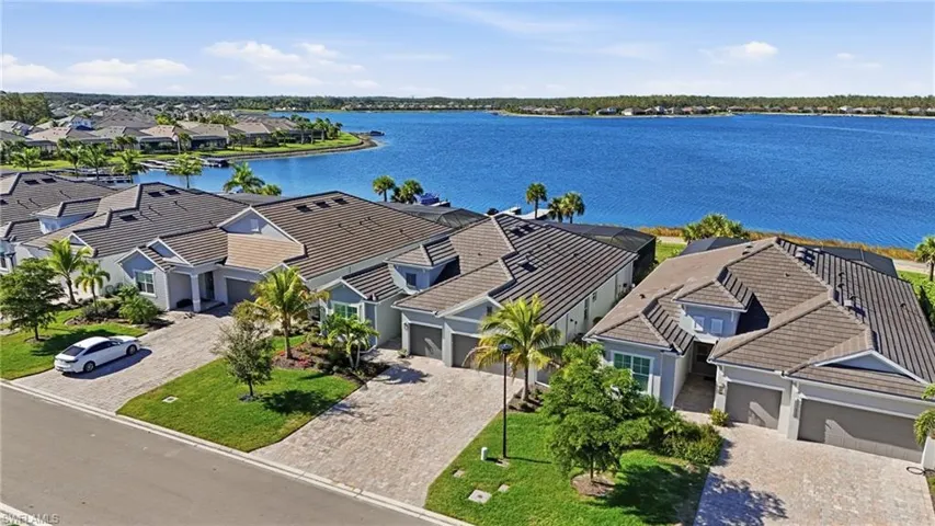 Aerial perspective of suburban area with a nearby body of water