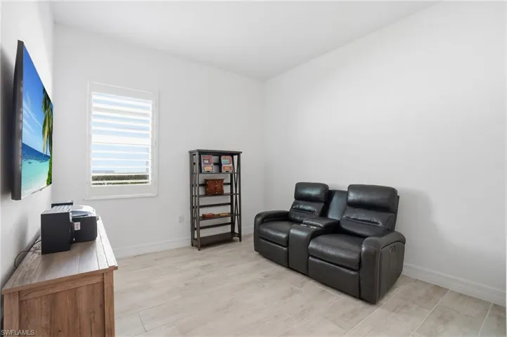 Sitting room featuring baseboards and light wood-style floors