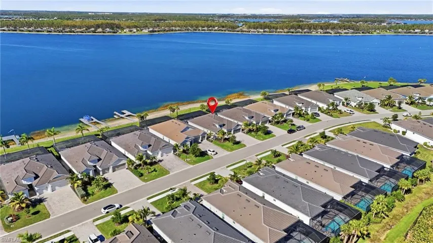 Aerial perspective of suburban area with a nearby body of water