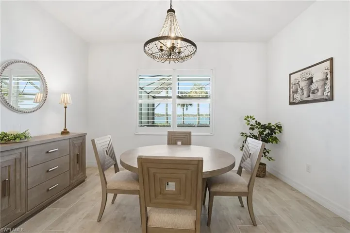 Dining space featuring a chandelier and wood tiled floors
