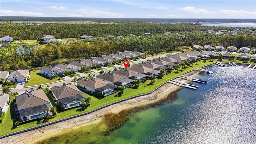 Aerial overview of property's location with a large body of water and nearby suburban area