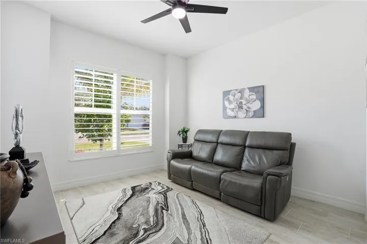 Living area featuring light wood-style flooring and a ceiling fan