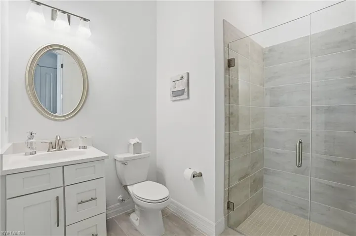 Full bathroom with vanity and a shower stall
