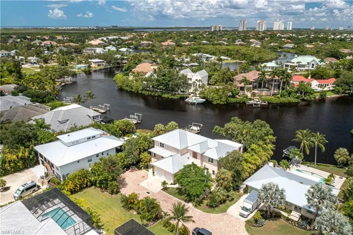 Aerial view of residential area featuring a nearby body of water