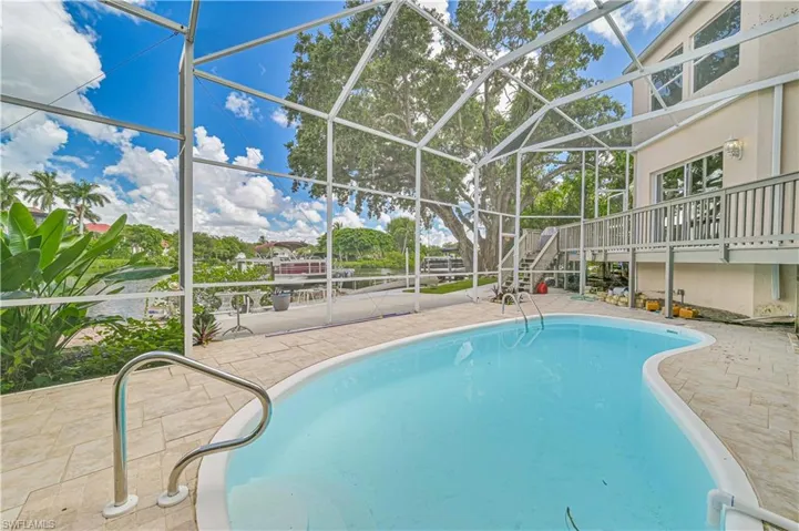 Outdoor pool with a patio area and a lanai