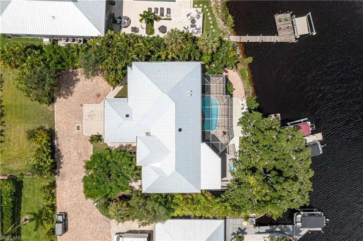 Drone / aerial view of a large body of water and a pool area
