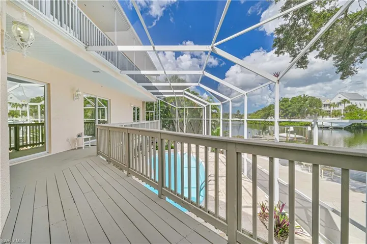 Deck featuring a water view and an outdoor pool