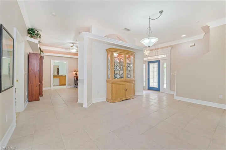 Entryway with ornamental molding, light tile patterned floors, a ceiling fan, and recessed lighting