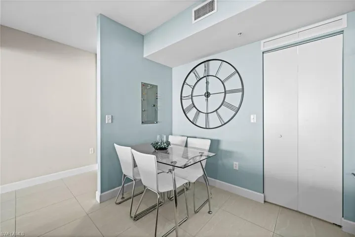 Dining area featuring light tile patterned floors and electric panel