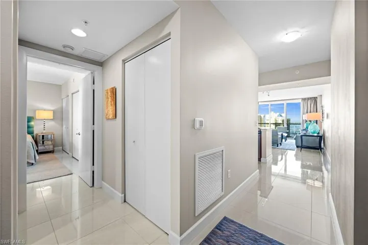 Hall with light tile patterned floors and baseboards